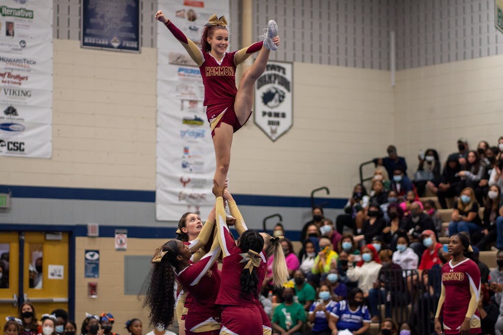 Squad of Cheerleaders Doing a Stunt